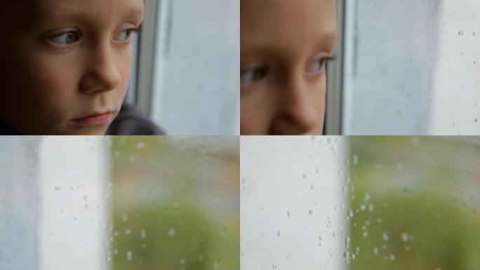 悲伤的男孩在下雨的天气里看着窗外