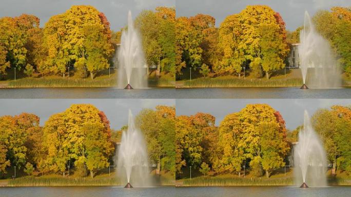 秋天公园里五颜六色的树叶。Lithunia的Druskininkai带喷泉的湖。美丽的秋天风景，五颜