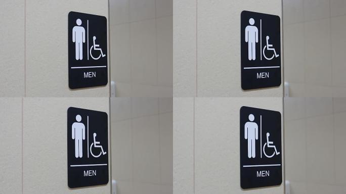 墙上的人和残疾人洗手间标志的运动
