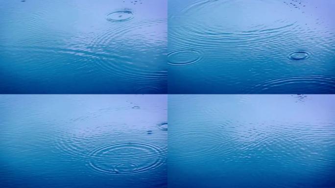 雨季近距离雨滴落到河面的蓝色色调，4K Dci分辨率