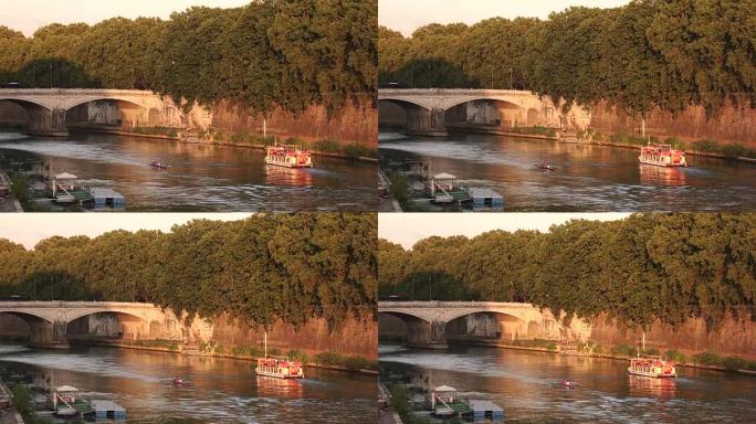 船和独木舟漂浮在被绿树环绕的桥附近的河上