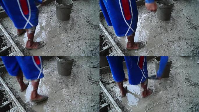 从混凝土搅拌机中浇注的铲土混凝土灌浆的施工作业