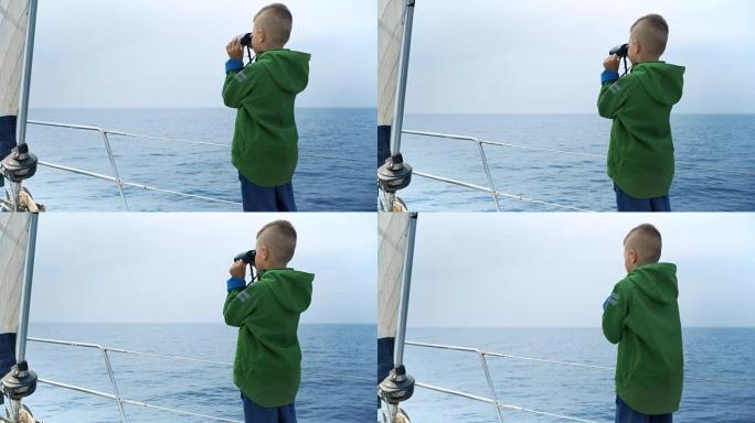 小男孩站在游艇上，看着双眼