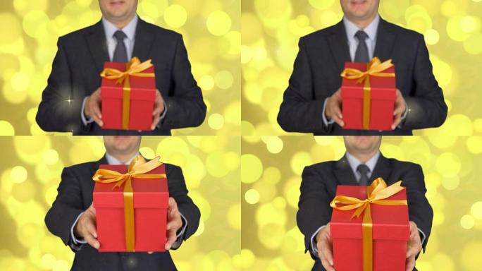 一个穿着西装打着领带的男人拿着一个红色的礼品盒。一个人送了一份礼物。一个手里拿着礼物的商人。抽象背景