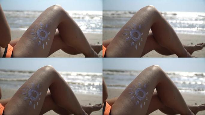 女人的腿上涂有奶油的阳光，靠海