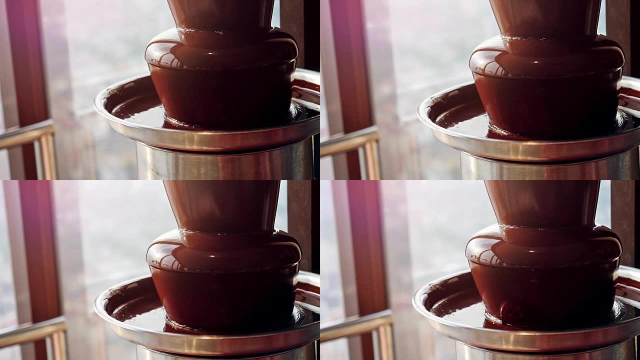 液体巧克力流。热熔巧克力喷泉瀑布。液体热巧克力的特写镜头。慢动作。1920x1080