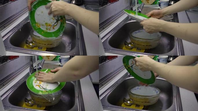 女人清洗和漂洗绿色盘子