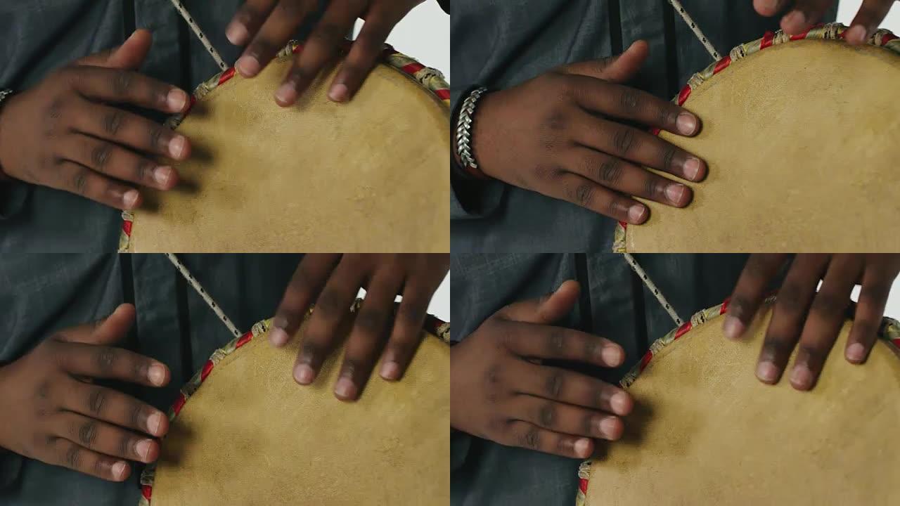 特写非洲人在djembe鼓上演奏的手