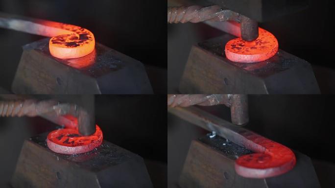 铁匠工作的艺术。铁匠大师在铁匠铺的铁砧上锻造红热铁。锻造，拧，砸铁。