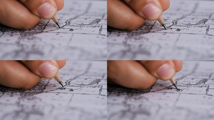 手持铅笔表示地理地图上的一个点，特写