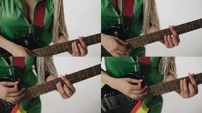 双手特写流行摇滚明星以慢动作演奏折衷的吉他