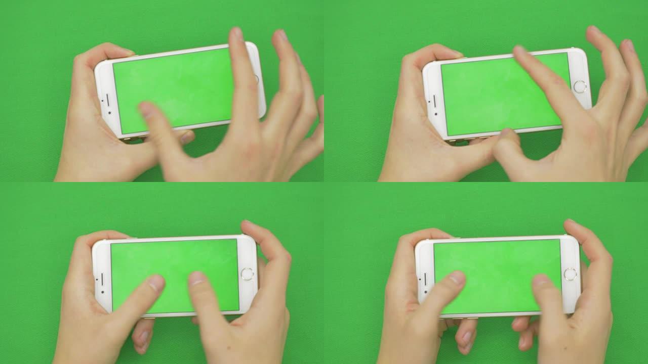 在绿屏上使用智能手机，具有各种手势，水平，特写-绿屏