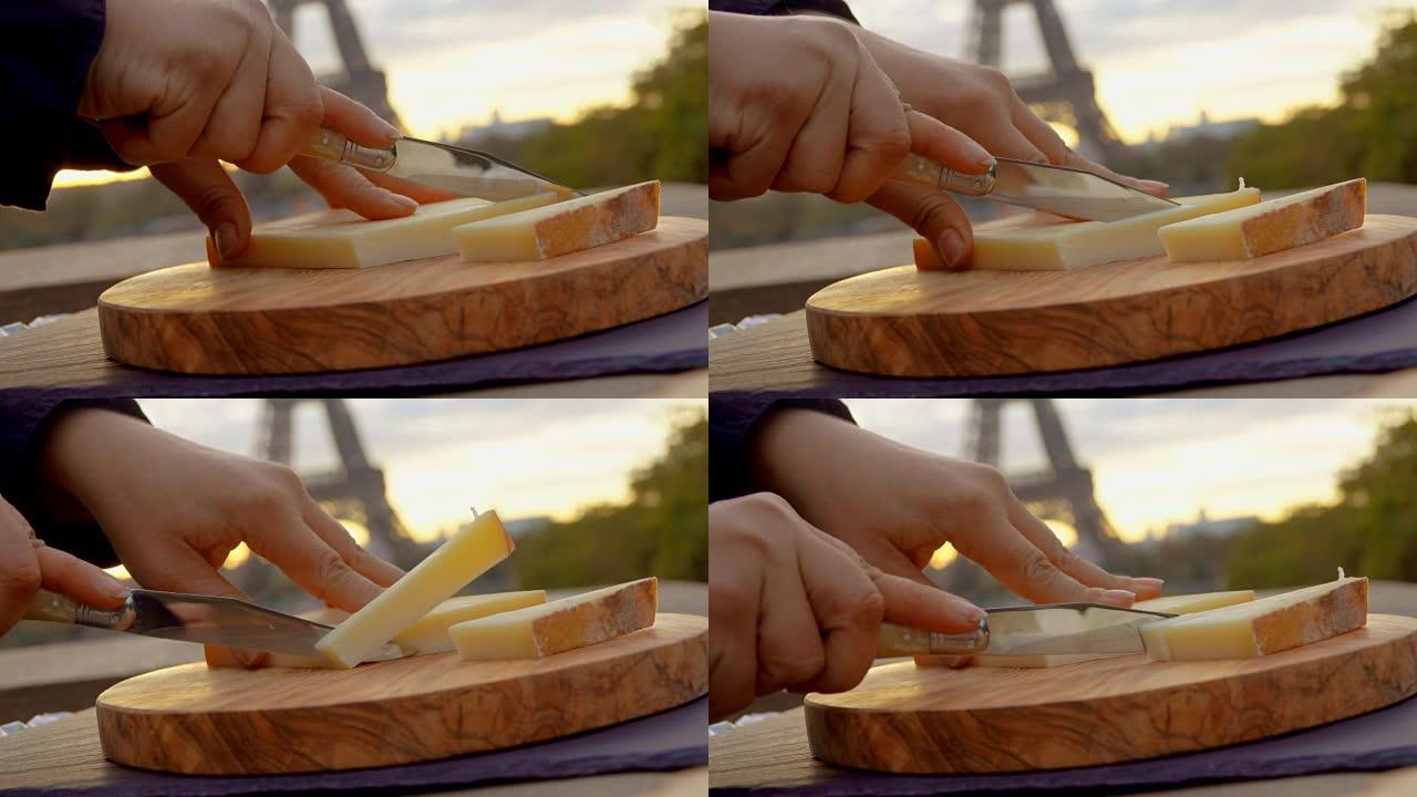 双手的特写刺伤了一块帕尔马干酪