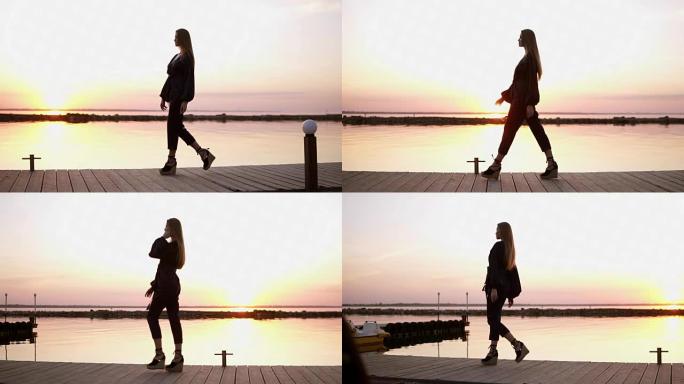 慢镜头，镜头从一边美丽的长头发的黑衣女子走在木码头。清晨黄昏，阳光洒在后台