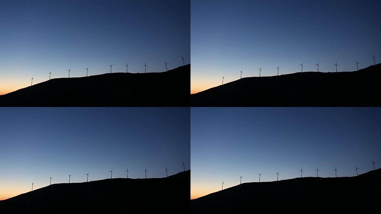 日落时风车在运动。凯法利尼亚。爱奥尼亚群岛。希腊。欧洲