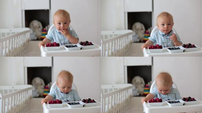 可爱的小男孩，在家吃新鲜水果，坐在儿童房的婴儿椅上。