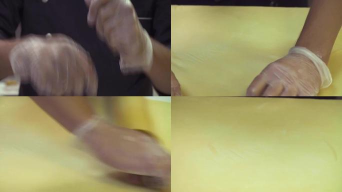 厨师将面团卷成薄片