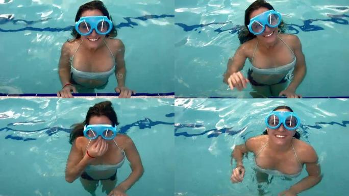 年轻的白人妇女戴着愚蠢的电子挡风玻璃雨刷太阳镜在游泳池里玩得开心