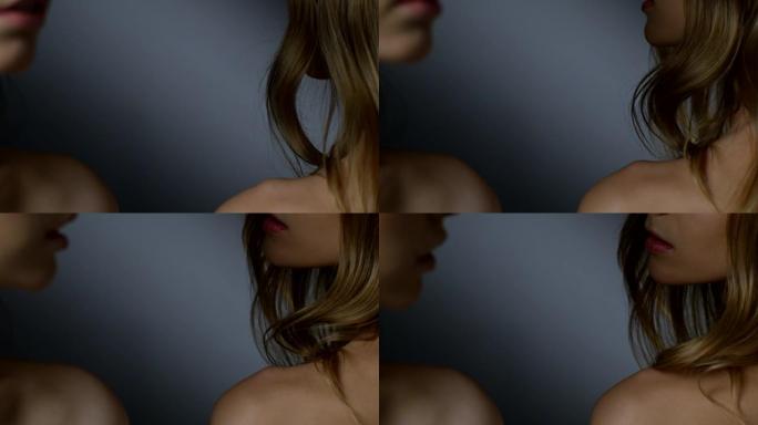 黑发和金发时装模特的身体上部 (背部，肩膀，脖子，锁骨，下巴，嘴巴) 的特写。模特们互相看着对方。时