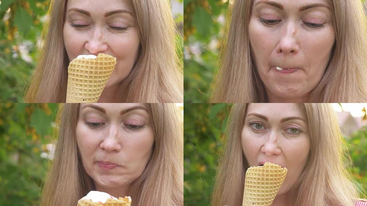 女人舔冰淇淋。这个女孩正在舔美味的奶油冰淇淋。草莓味冰淇淋蛋卷是她最喜欢的夏季菜肴。日落光线照在镜头