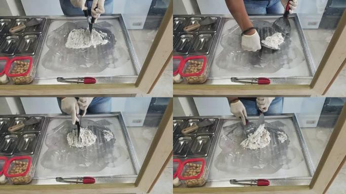 使用冰冷的金属结构手工生产商店中的冰淇淋