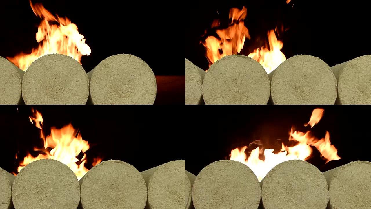 木制木屑生态煤球，冬天在雪地上燃烧的背景火。替代燃料，生物燃料。滑块镜头。