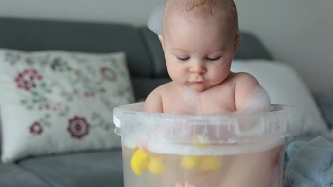 Cute little four month old baby boy, playing in bu