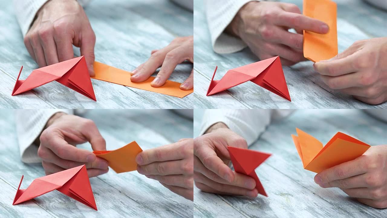 特写男人折叠折纸图。