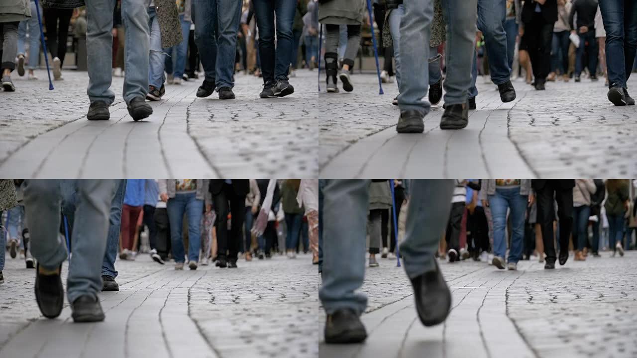 人群的脚在慢动作中走在街上