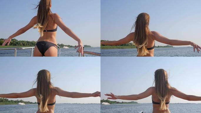 美丽的女孩身材泳装举起双手，享受夏天的大自然自由