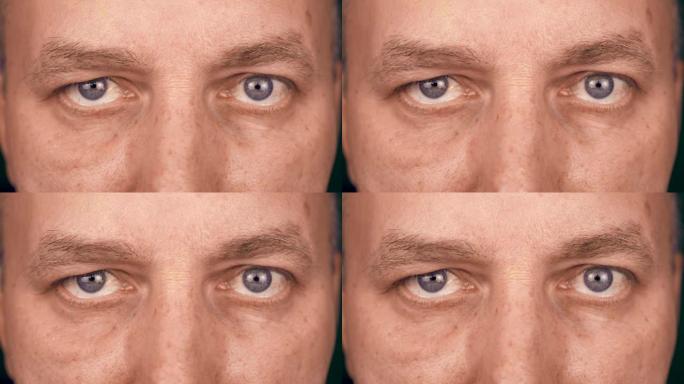 成年白人男子的极端近距离眼睛。男人脸的前视图。男人看着镜头。男性视线向前冻结。