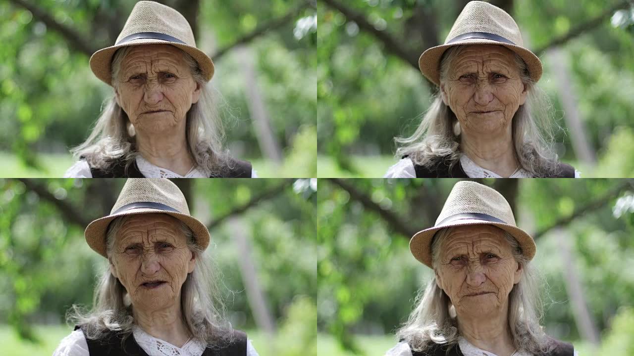 户外一位戴着草帽的白发老妇的肖像。