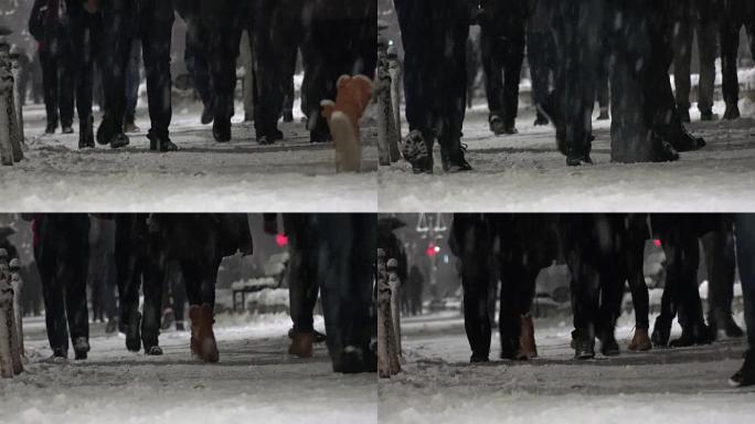 人们在冬天的雪上穿靴子。人群在城市公园晚上散步。鞋子特写