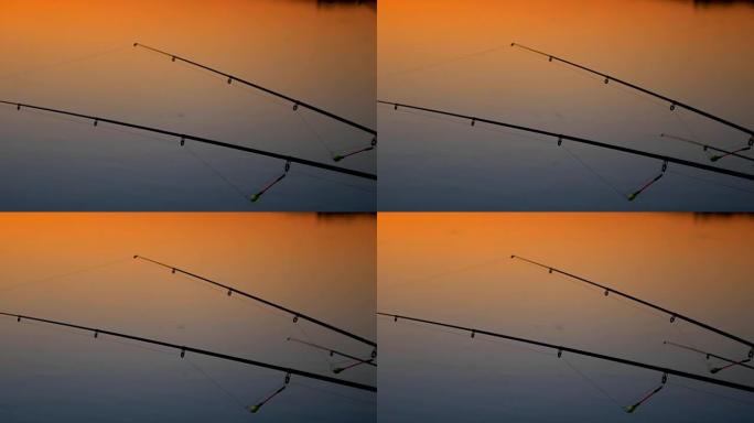 日落河上的钓鱼竿。背景早晨天空中的钓鱼竿。