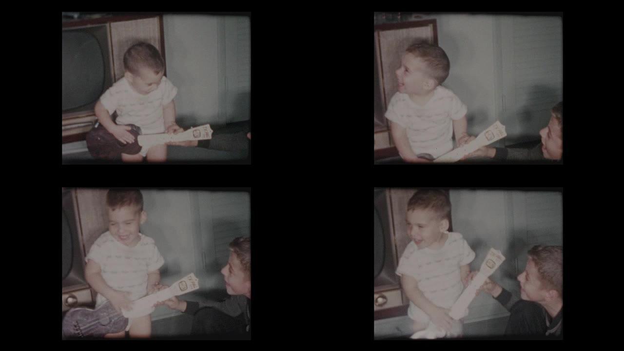 2岁小男孩玩玩具吉他