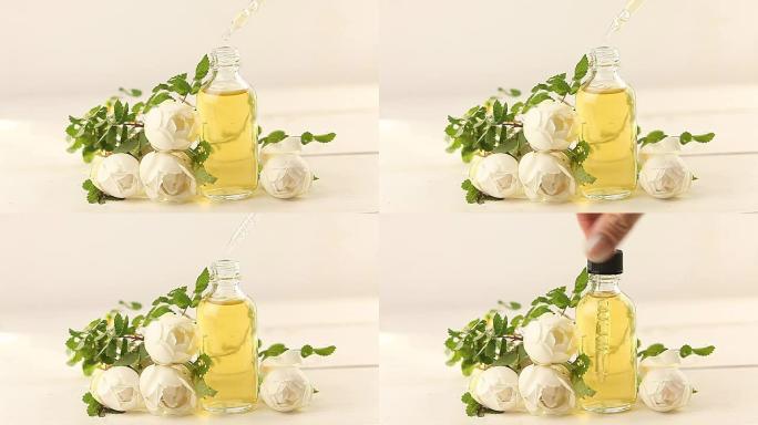 美丽玻璃罐中白色背景上的花朵精华