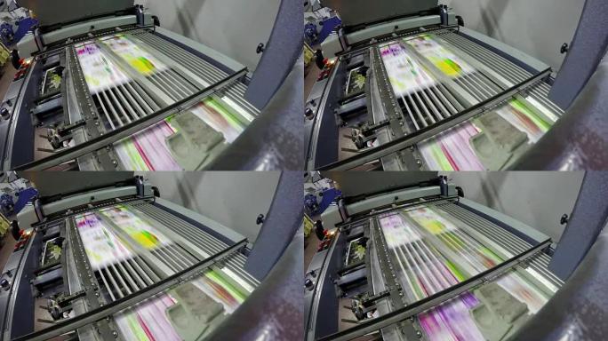 折叠机折叠印刷的胶版纸，作为印刷屋报纸手册的一部分。UHD股票视频循环