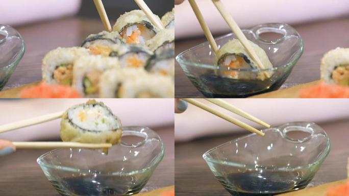 寿司保持筷子，蘸酱。
