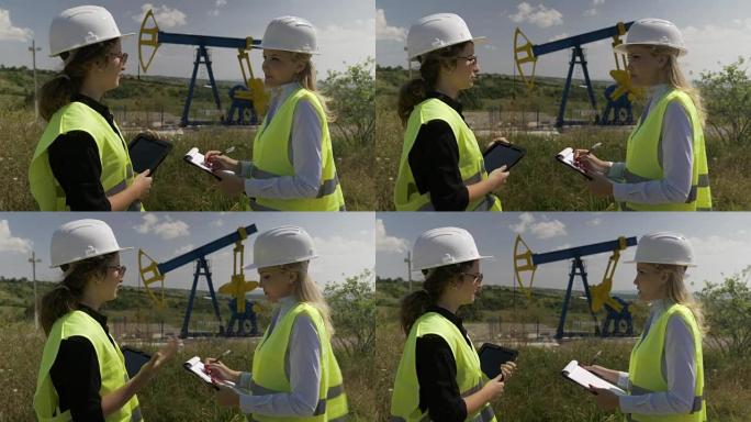 实习中的年轻女学生技术员向执行经理报告钻井油泵附近的工程工作进展