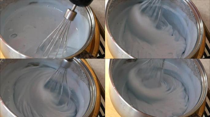 在金属碗中形成郁郁葱葱的奶油蛋ust浇头的过程，该金属碗位于自动搅拌机中。