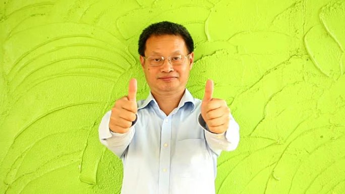 绿色墙的泰国男子
