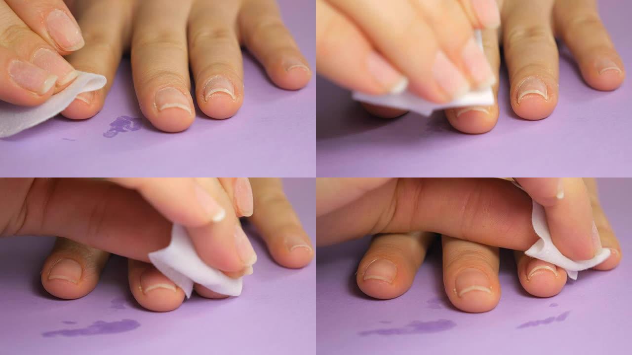 在美容院用餐巾纸处理女人的指甲，然后再盖上盖子。