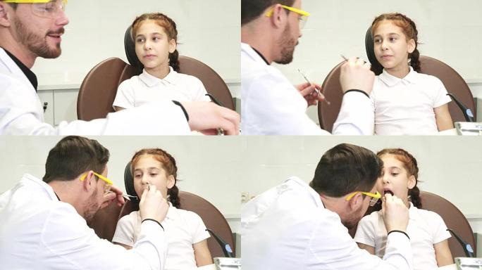 一位善良的医生检查了一个小女孩的牙齿