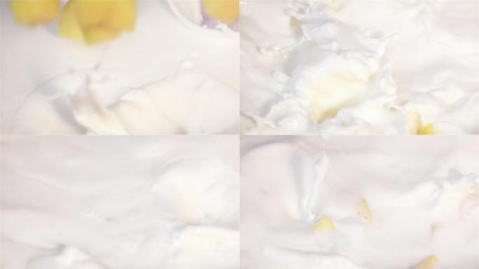 芒果在真实慢动作中掉入牛奶的视频