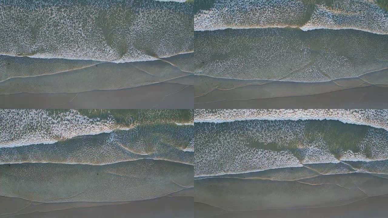 偷听海浪在岸上坠毁的空中无人机镜头