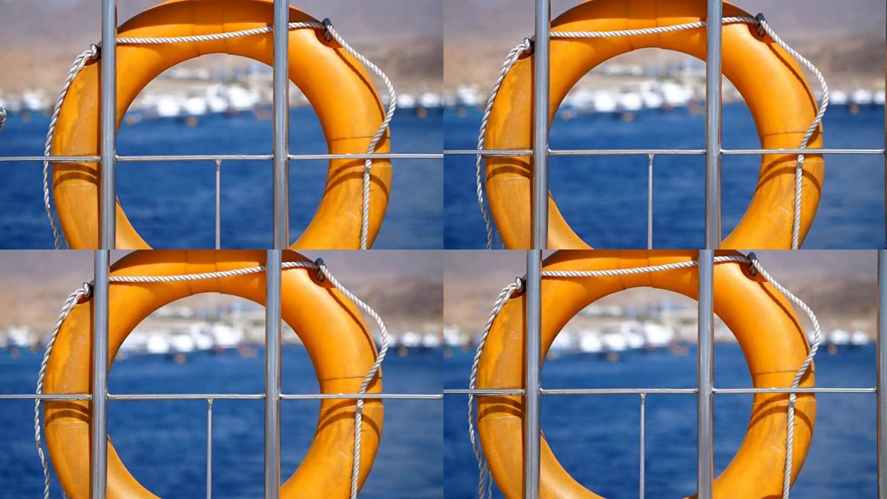 夏天，大海，橙色救生圈，挂在渡轮上，船上。船的特殊救援设备。拯救一个溺水的人的生命