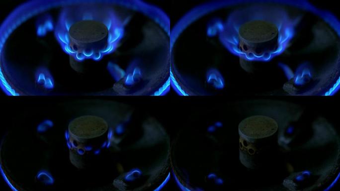 燃气灶燃烧器蓝色火焰的特写镜头。慢慢调整燃气灶上的火级并关闭。液态石油气。