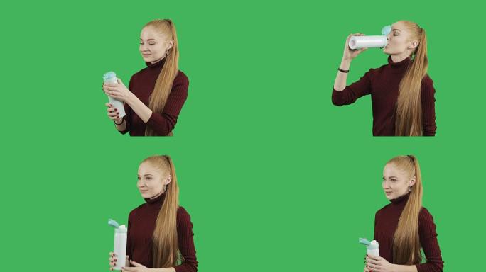长发红头发的女性高加索模特正在喝时尚保温杯中的热咖啡或茶。