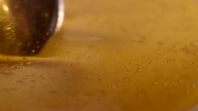 用勺子搅拌蜂蜜的特写