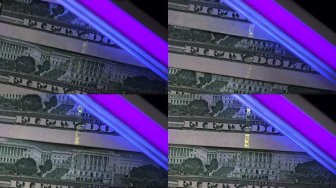 在紫外线下扫描美元钞票的特写镜头。